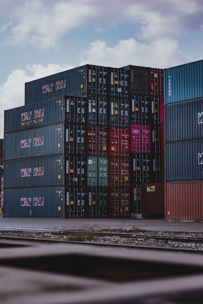 pexels-photo-3735930 High vertical stack of cargo containers at a port, symbolizing global logistics.
